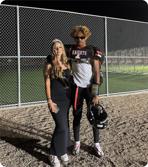 Eine Schülerin mit einem Footballspieler Abends im Stadion beim Schüleraustausch