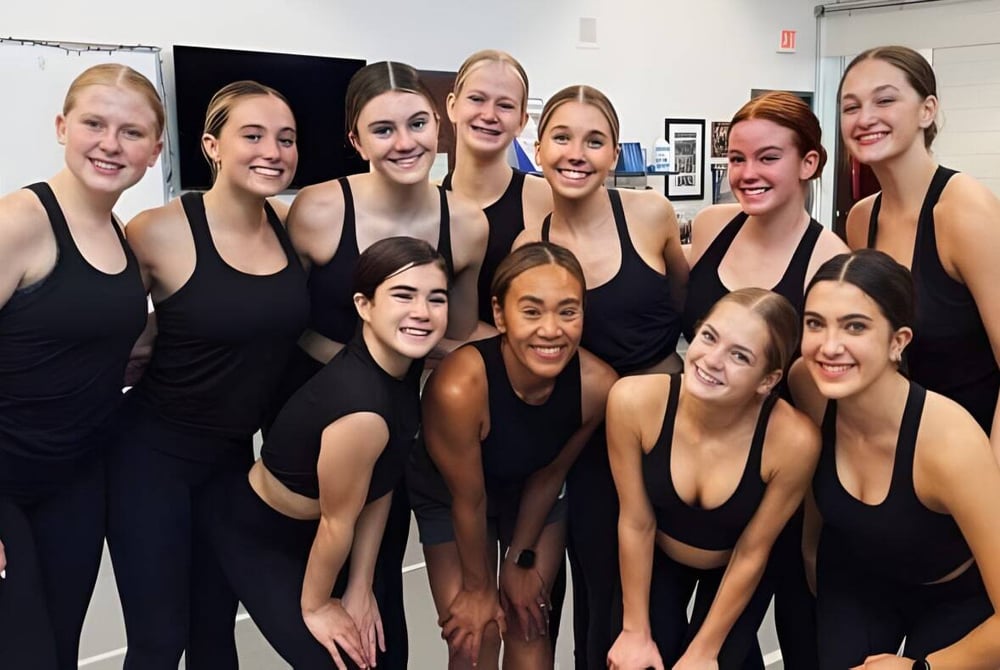 Eine Gruppe Schülerinnen der Arcadia High School posiert in einem Tanzstudio in schwarzer Tanzkleidung.