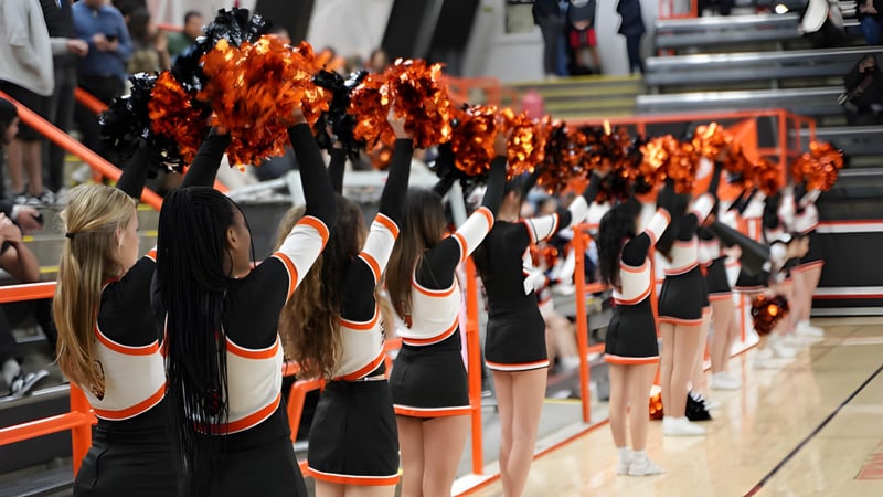 Die Cheerleading-Kostüme der Beverly High School mit Pompons stehen in einer Sportarena bereit.