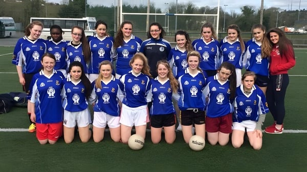 Eine Gruppe junger Fußballspielerinnen posiert auf dem Sportplatz der Blackwater Community School.