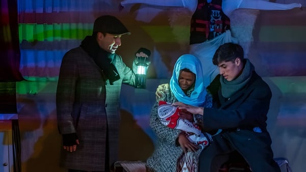 Drei Personen stehen in einem farbig beleuchteten Raum auf dem Campus des Bournemouth & Poole College.