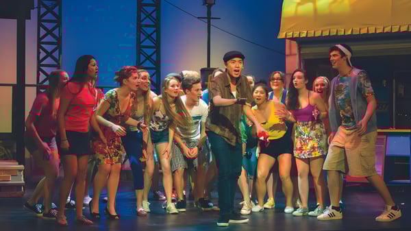 Eine Gruppe Schüler auf der Bühne der Brentwood College School vor Bühnenbeleuchtung und Equipment.