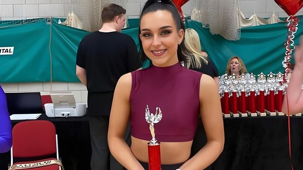 Eine lächelnde Frau steht in einem Veranstaltungsraum auf dem Campus der Bromsgrove School.