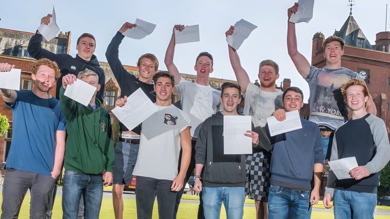 Eine Gruppe von Schülern feiert draußen vor einem historischen Gebäude auf dem Campus des Campbell College.