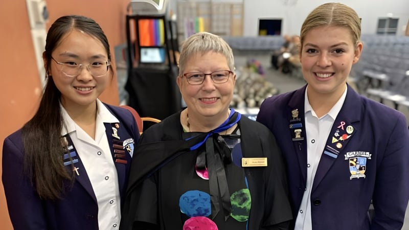 Drei Frauen in Uniform stehen zusammen in einem Innenraum auf dem Campus des Carmel College.
