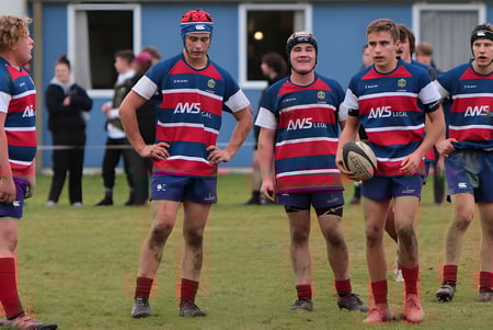 Schüler des Central Southland College stehen in Rugby-Uniform auf dem Sportplatz vor einem Gebäude.