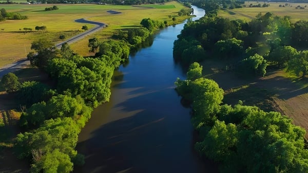 Ein ruhiger Fluss fließt durch eine grüne Landschaft in der Nähe der Central Yorke School.