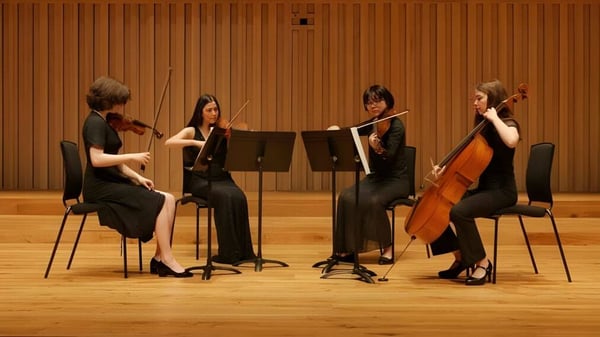 Ein Streichquartett spielt auf der Bühne der Chetham’s School of Music vor einer hölzernen Wandverkleidung.