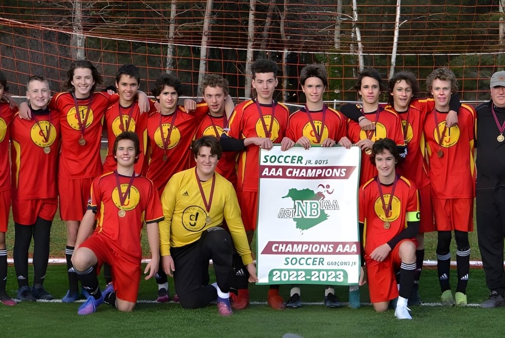 Schüler der Cité des Jeunes A.-M.-Sormany halten stolz das Siegerbanner der AAA-Meisterschaft der Saison 2022-2023.