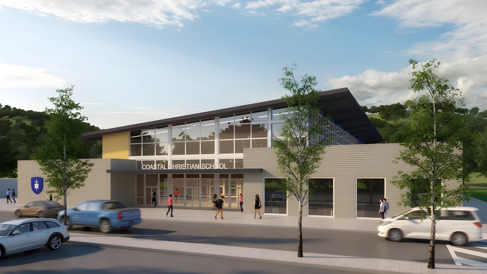 Das moderne mehrstöckige Gebäude der Coastal Christian School mit Glasfassade steht in urbaner Umgebung mit Bäumen und parkenden Fahrzeugen.