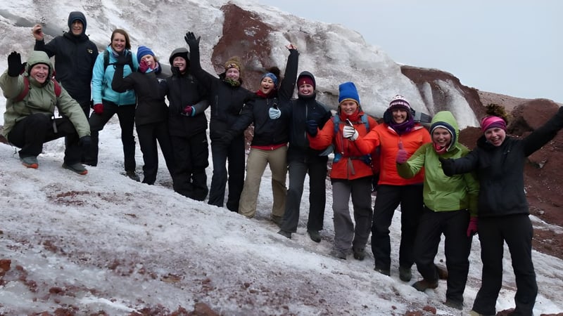 Schüler der Coláiste an Chreagáin stehen zusammen in winterlicher Berglandschaft mit Schnee bekleidet.