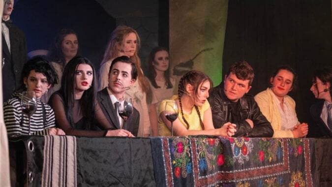 Eine Gruppe von Schülerinnen und Schülern der Colaiste Muire (Cobh) steht gemeinsam auf der Bühne vor buntem Hintergrund.