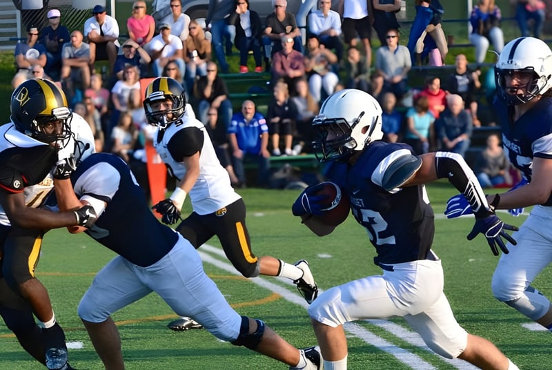 Eine Gruppe Fußballspieler des College Bourget spielt ein Spiel auf einem Rasenfeld mit Zuschauern im Hintergrund.