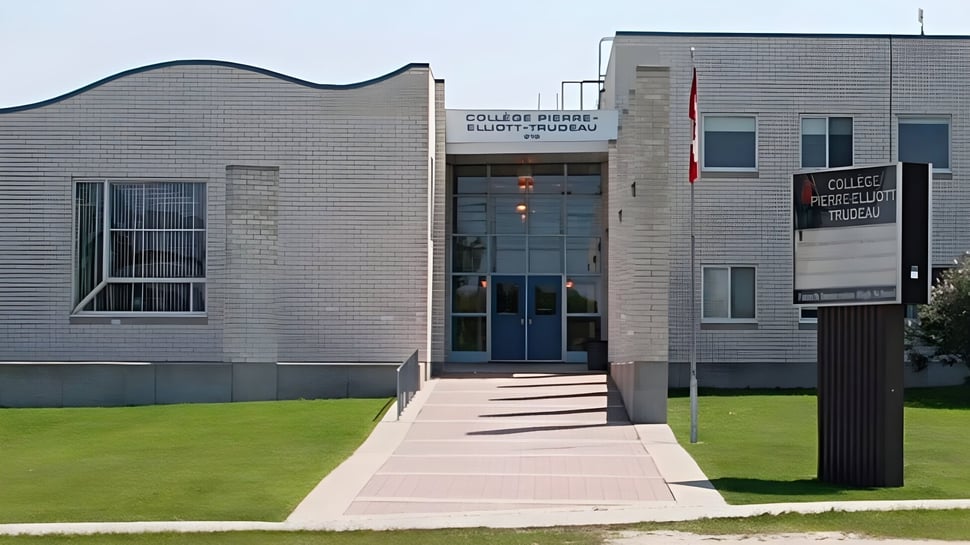 Das moderne mehrstöckige Gebäude mit geschwungener Fassade und großen Fenstern steht auf dem Rasen vor dem Collège Pierre-Elliott-Trudeau.