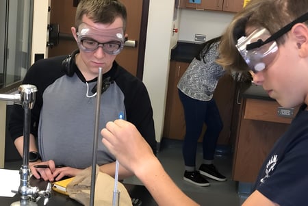 Zwei Schüler der Fleetwood Park Secondary School untersuchen ein Gerät im Werkstattlabor.