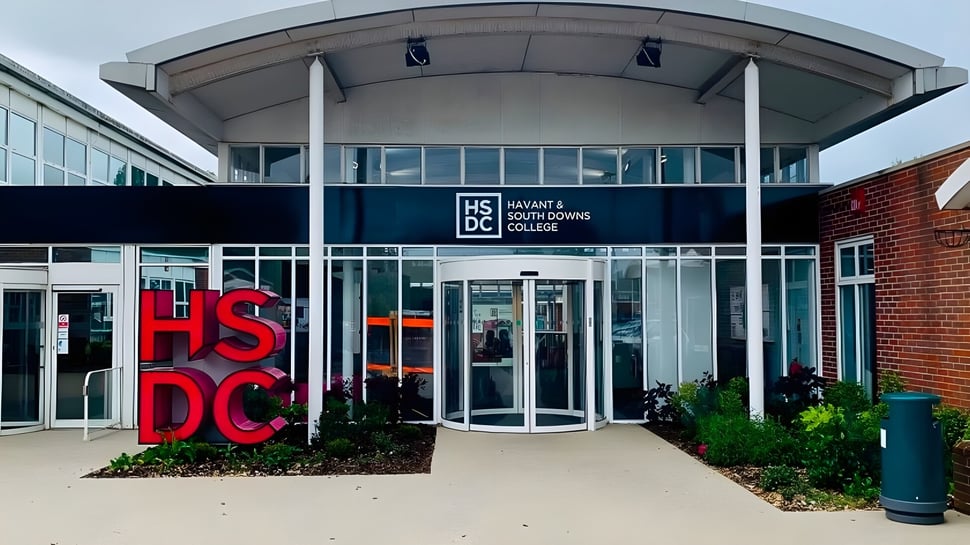 Das moderne Glas- und Backsteingebäude mit großen roten Buchstaben HSDC auf dem Campus des Havant College.