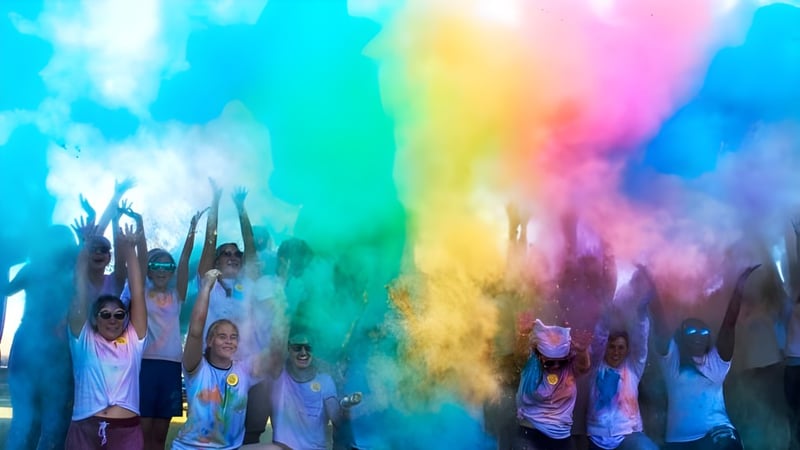 Schüler der Indian River Charter High School feiern mit buntem Farbpulver bei einer Festveranstaltung.