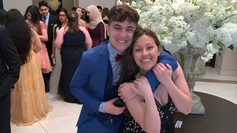 Eine Gruppe Schüler der Iroquois Ridge High School posiert gemeinsam in einem festlichen Rahmen mit Blumendekoration.