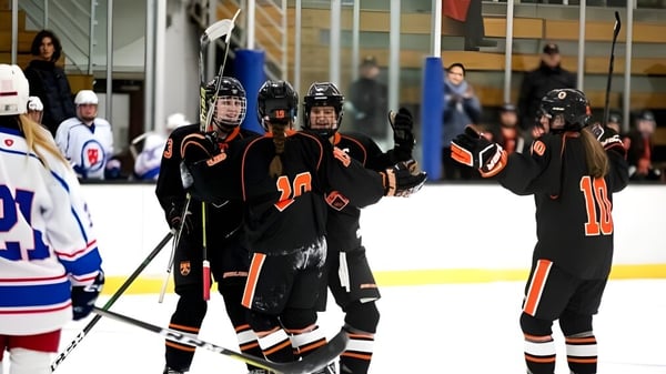 Schüler der Kimball Union Academy spielen Eishockey auf dem Eis vor Zuschauern.