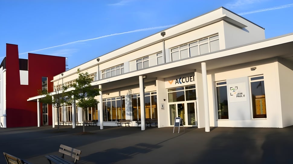 Das moderne Gebäude des Lycée Immaculée Jean Paul II zeichnet sich durch große Fenster und einen markanten Eingang aus.