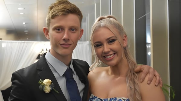 Ein junges Paar posiert gemeinsam bei einem formellen Anlass auf dem Campus der Mackay North State High School.