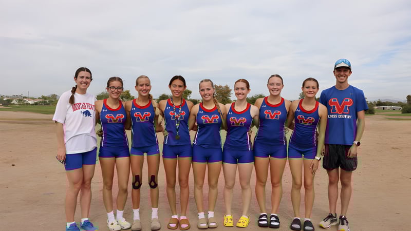 Eine Gruppe junger Athletinnen der Mountain View High School steht auf einem Sportfeld unter bewölktem Himmel.