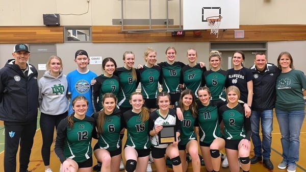 Eine Gruppe von Schülerinnen und Schülern der Nanaimo District Secondary School posiert in der Turnhalle vor einem Basketballkorb.