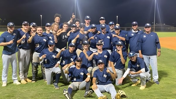 Schüler der North Broward Preparatory School feiern bei Nacht auf dem Baseballfeld ihren Sieg.