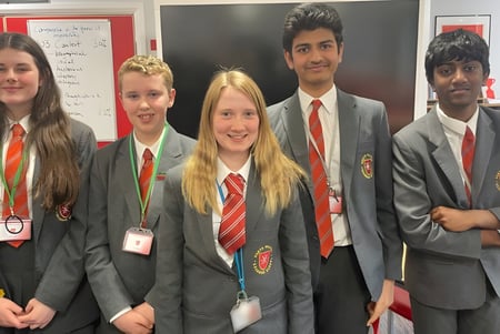 Eine Gruppe Schüler der North Halifax Grammar School steht gemeinsam im Klassenraum in Schuluniformen.