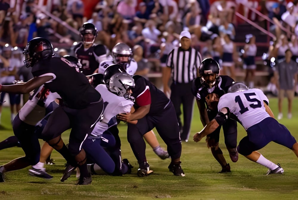 Schüler der Northside Christian Academy spielen auf dem Fußballfeld vor einer großen Zuschauermenge.