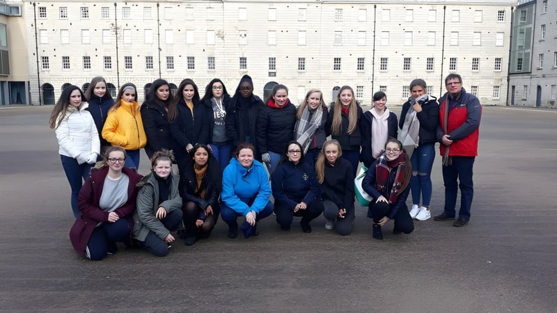 Eine Gruppe Schülerinnen steht vor dem großen weißen Gebäude des Our Lady's College.