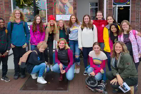 Eine Gruppe von Schülerinnen und Schülern steht auf dem Außengelände der Parkland Secondary School vor einem Backsteingebäude.