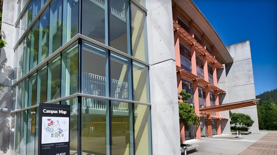 Das moderne Gebäude der Phoenix Magnet Academy mit einem Campus Map Schild bei klarem Himmel.