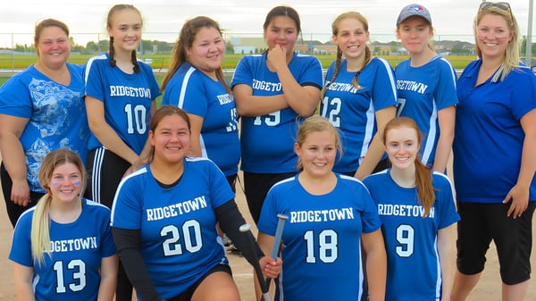 Eine Gruppe junger Sportlerinnen steht gemeinsam auf dem Sportplatz der Ridgetown District High School.