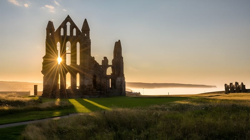 Die Ruinen einer Abtei sind auf dem Gelände der Rossall School vor einer landschaftlichen Kulisse mit Sonnenstrahlen durch die Fenster zu sehen.