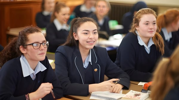 Eine Gruppe Schülerinnen der Royal Masonic School for Girls sitzt im Klassenzimmer an Tischen und arbeitet gemeinsam.