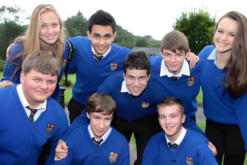 Eine Gruppe von Schülerinnen und Schülern der Royal & Prior Comprehensive School posiert draußen auf einer Wiese mit Bäumen im Hintergrund.