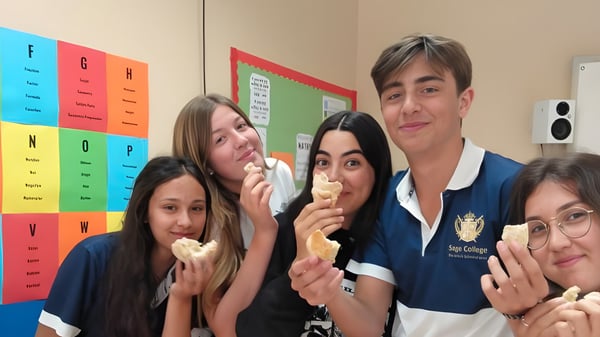 Schüler des Sage College genießen eine Pause im Klassenzimmer mit bunten Lehrplakaten an den Wänden.