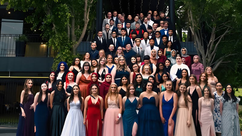 Eine Gruppe von Schülerinnen und Schülern der Salisbury High School versammelt sich im Freien vor grüner Kulisse.