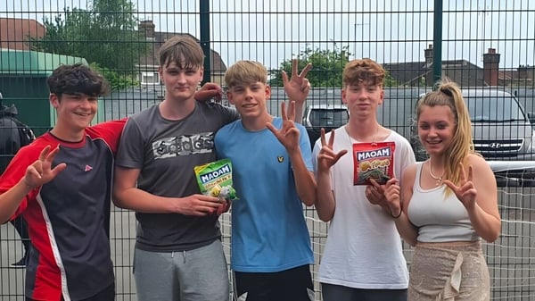 Eine Gruppe von Schülerinnen und Schülern steht vor einem Drahtzaun auf dem Gelände des Salisbury Sixth Form College.