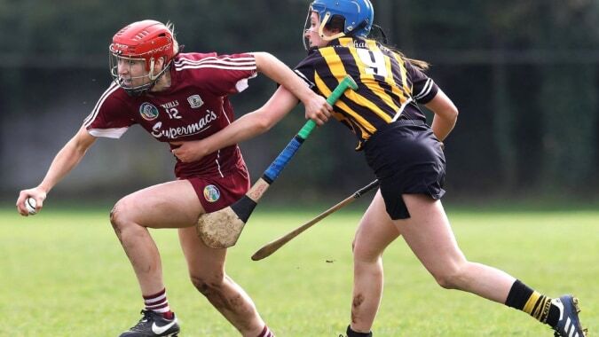 Zwei Spieler kämpfen um den Ball bei einem Sportspiel auf dem Spielfeld der Scoil Mhuire Kanturk.
