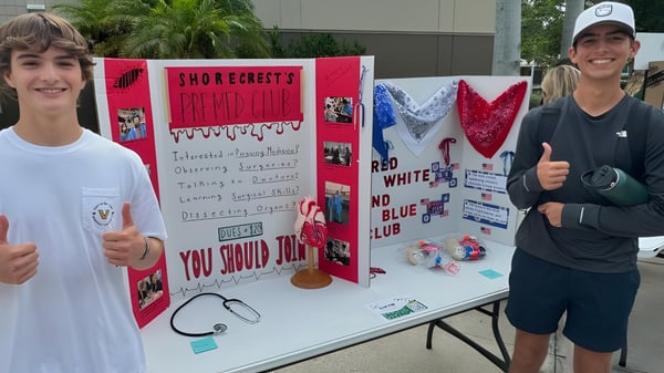 Zwei Schülerinnen und Schüler stehen vor einer Informationswand auf dem Campus der Shorecrest Preparatory School.