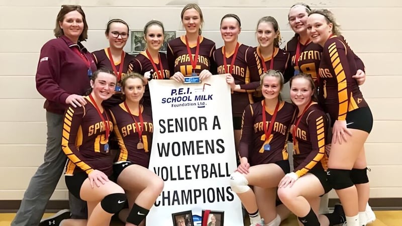Schülerinnen der Souris Regional School feiern als Senior A Damen Volleyballmeister mit einem Banner.
