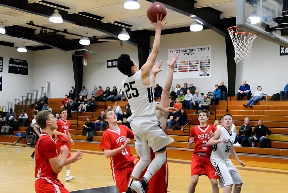 Ein Basketballspiel in der Turnhalle der St. Francis Xavier High School zeigt eine Schülerin im weißen Trikot beim Wurf zum Korb.