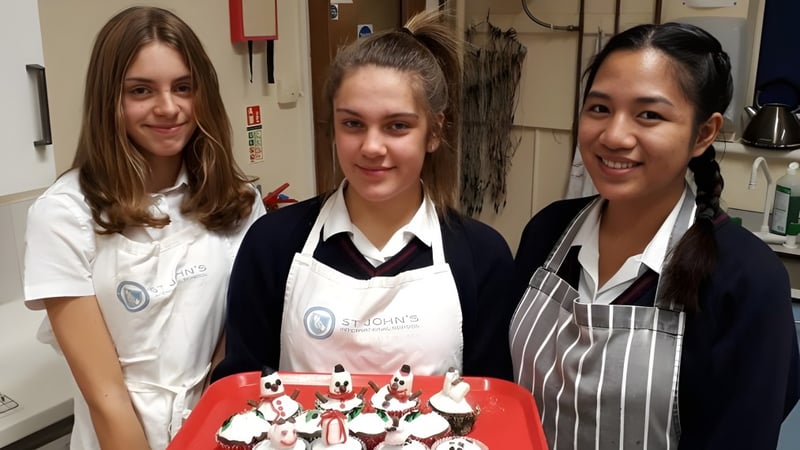 Drei Schülerinnen der St. John’s School Sidmouth stehen gemeinsam in einer Schulküche.