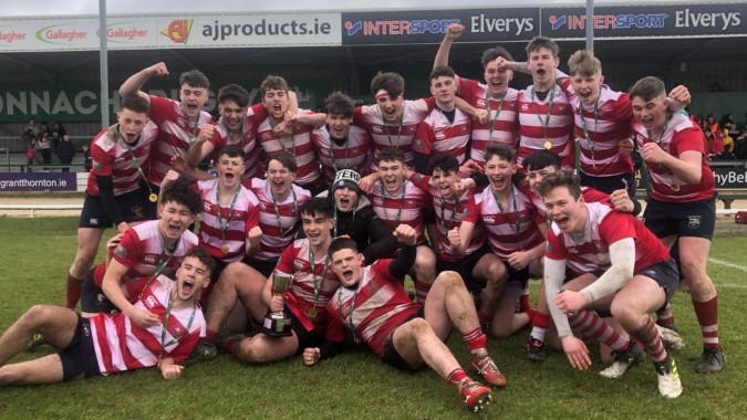 Eine Gruppe von Rugby-Spielern feiert auf dem Spielfeld des St. Muredach's College.