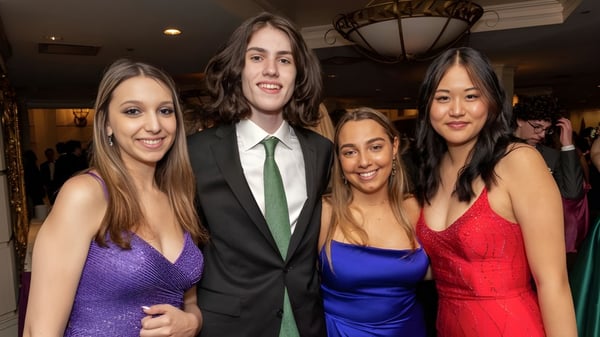 Vier Schülerinnen und Schüler der Stamford High School sind bei einer formellen Veranstaltung zusammen in eleganter Kleidung zu sehen.