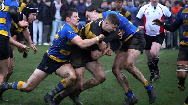 Zwei Rugbyspieler in gegnerischen Trikots führen auf dem Feld während eines Spiels an der Stowe School einen Körperkontakt durch.