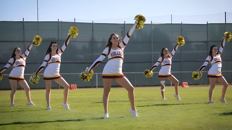 Eine Gruppe Cheerleader führt eine Choreografie auf dem Sportplatz der Valley Christian High School auf.