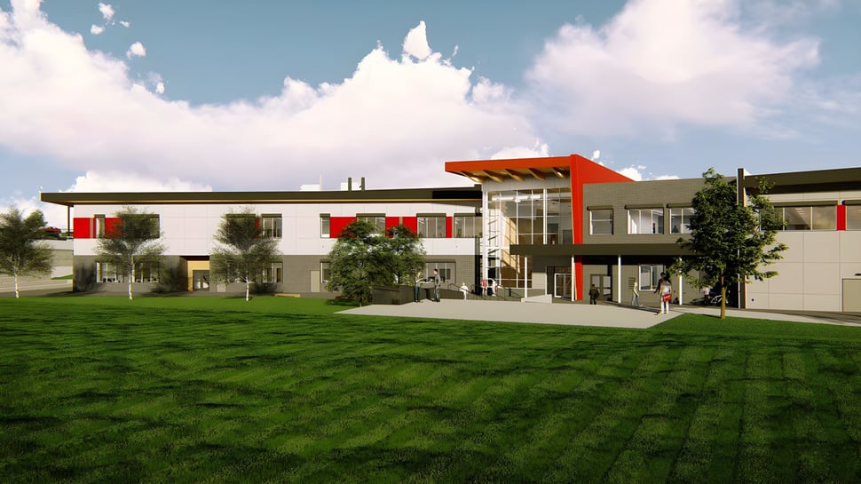 Das moderne mehrstöckige Gebäude der Valleyview Secondary School steht auf einer Wiese unter einem bewölkten Himmel.